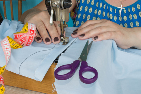 processes of sewing on the sewing machine sew women's hands sewing machine. sewing machine and...