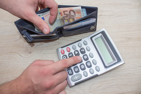 man, Hands calculator to count money. Man using calculator and calculate money in home office