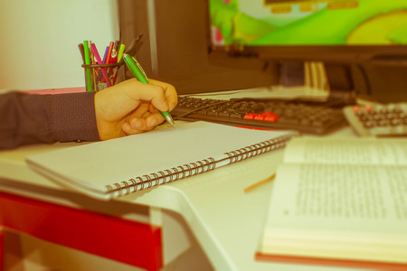 closeup pen on paperwork accounts with man use computer to save data in background. accounting concept. Man hand with pen, calculator and computer on wooden table - Retro colorの写真素材