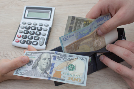 finances, currency, exchange rate, business and people concept - close up of male and female hands...