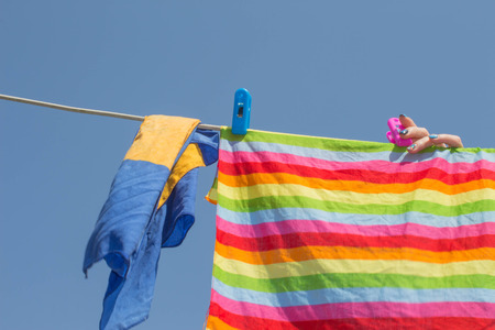 Drying of things in nice and sunny day. Hand hanging things against blue skyの写真素材