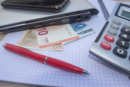 calculator, Money on the table. Savings, finances, economy, Business and home concept - Female with calculator counting money and making notes at home. Business Objects in the office on the tableの写真素材