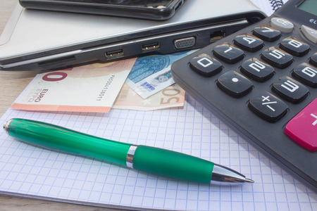 Business Objects in the office on the table, calculator and dollars on table. Money and a calculator on the tableの写真素材