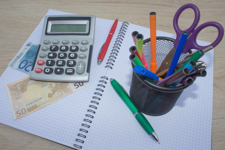 Business Objects in the office on the table, calculator and dollars on table. Money and a calculator on the tableの写真素材