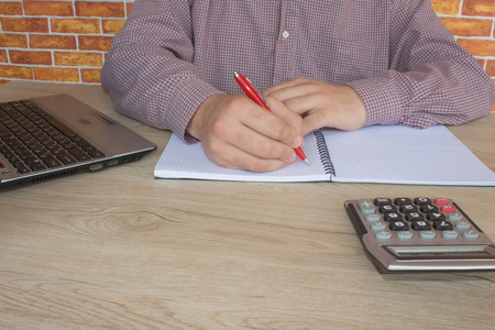 Businessman using a calculator to calculate the numbers. Accounting , Accountancy, Calculation...