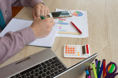 Businessman using a calculator to calculate the numbers. Accounting , Accountancy, Calculation...