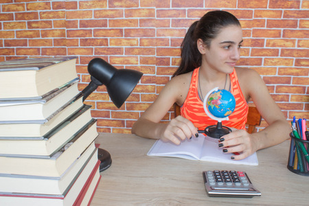 Young Girl studying on desk at home. Thoughts, education, creativity conceptの写真素材