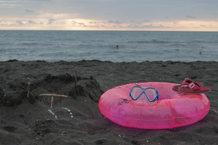 Sand castle, swimming glasses and Floating Ring on beach. Travel concept. Vacation backgroundの写真素材
