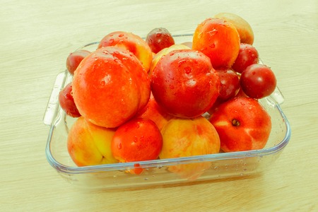 Beautiful sweet peaches, nectarine and plums. Ripe fruit on the table - Retro colorの写真素材
