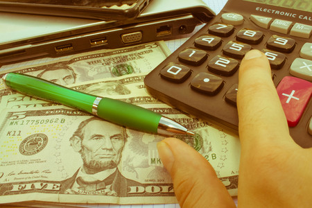 Calculator and money on wooden table. The concept of financial planning, savings. Business Objects in the office on the table, calculator and money on table - Retro colorの写真素材