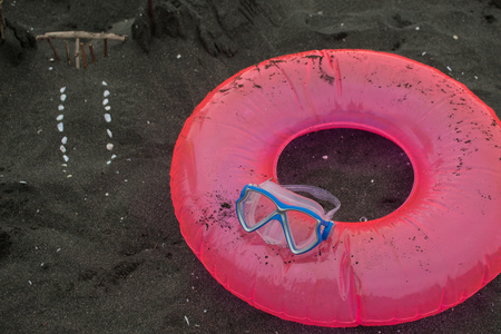Sand castle, swimming glasses and Floating Ring on beach. Travel or sea vacations concept. Beach lifeの写真素材