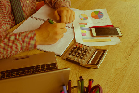 a business man working in home office table plan for business market analysis. Man hand with calculator at workplace offic. investment, economy, saving money or insurance concept - Retro colorの写真素材
