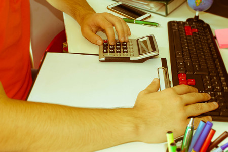 Hand with calculator. Finance and accounting business. Business male Analyzing Statistics Financial, business Concept - Retro colorの写真素材