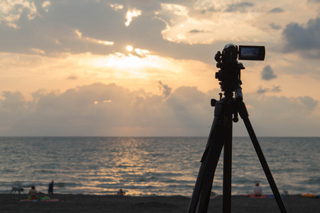 Digital Video Camera shooting the Beach at Sunset on sea.  twilight sky and cloud landscapeの写真素材