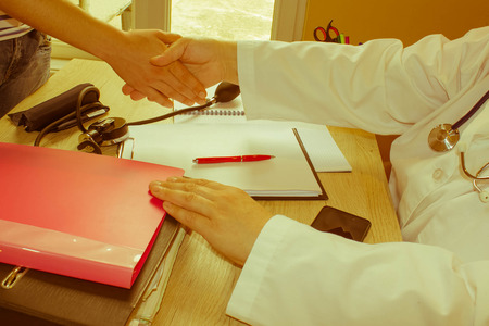 Medical and Health care concept. Doctor and young patient. medicine, age, health care and people concept - Retro colorの写真素材