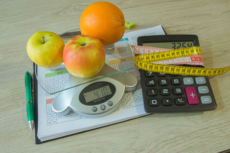 Concept of diet. Low-calorie fruit diet. Diet for weight loss. Measuring tape and fruits on the table. Vegetarian diet for weight loss. Fruit diet. Low-fat dietの写真素材