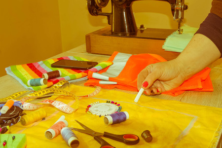 Female fashion designer working at studio with pattern cuttings and sketches. Garment industry, tailoring conceptの写真素材