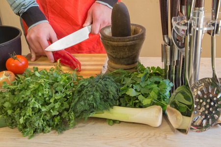 Man hands cutting vegetables on kitchen blackboard. Healthy food. Male preparing vegetables. Healthy...