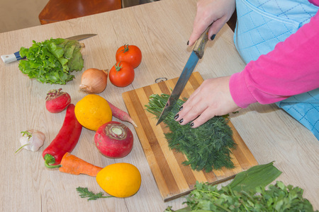 woman hands cutting vegetables on kitchen blackboard. Healthy food. Woman preparing vegetables. Healthy Foodの写真素材