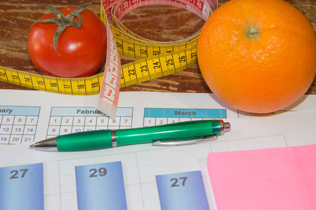 Citrus fruits, tomato. Measure tape and fresh fruit in the background. Healthy lifestyle diet with fresh fruits. Fruit dietingの写真素材