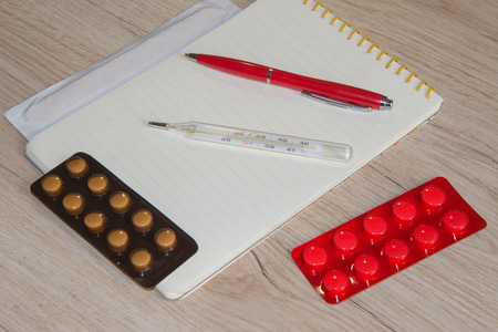 Doctor desk and medical equipment, Hospital concept. Stethoscope with black medical clipboard and medicineの写真素材
