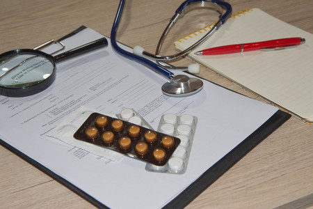 doctor workplace with a stethoscope at wooden table. Medical concept imageの写真素材