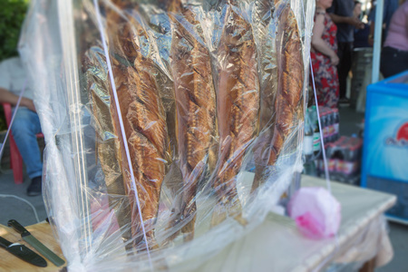 traditional fresh smoked fish On the market. Smoked fish. Food Industry. Group of smoked fishes. Food Industryの写真素材