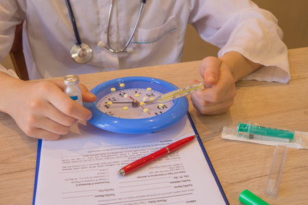 doctor concept in hostpital. big clock and pills are on the working table. Medical and Health care...