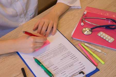 Medicine doctor's working table. Healthcare and medical concept. Doctor sits in a medical office in...