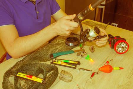 Close-up of a fisherman's hands with Accessories for fishing. fishing rod with accessories on...
