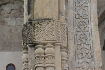 Stone ornament on the wall of an old temple Bagrati in Georgia. Carving stone ornament closeup in...