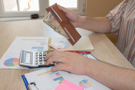 calculator, Money on the table. Savings, finances, economy, Business and home concept - men with...