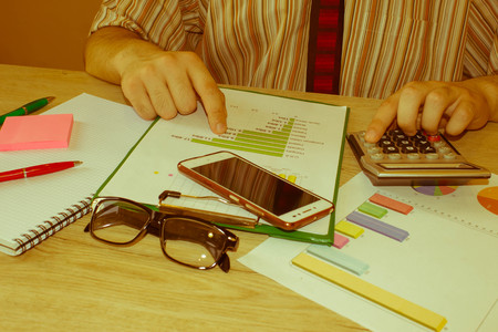 person Man see goals on a paper,writing business plan at workplace, Male working, papers, notes in documents, Saving money conceptの写真素材