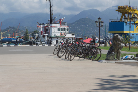 Rows of shared bicycle beside road in Batumi. New boulevard bicycles and tricycles rent station for touristの写真素材
