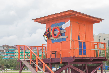 An wooden orange lifeguard tower on the beach In Batumiの写真素材