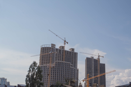 Crane and building construction. big building construction. Tower cranes against the building under constructionの写真素材