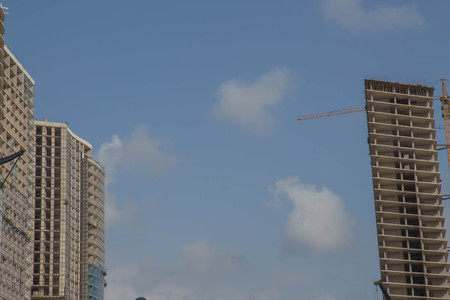 A crane in a construction work. Empty copy space for Editor's text. Modern civil engineering