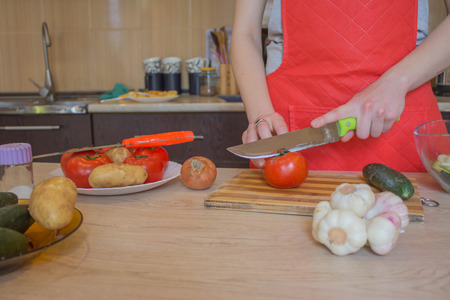 woman cooking healthy meal in the kitchen. Cooking healthy food at home. Woman in kitchen preparing...