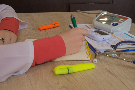 Doctor appoint prescription drugs to patients. Doctor working at table in office. Concept photo doctorの写真素材