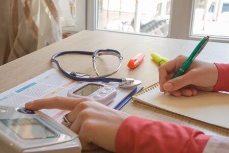 Doctor sitting at the desk near window. Healthcare and medical concept. Medicine doctor's working tableの写真素材