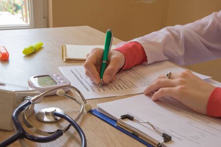 Doctor sitting at the desk near window. Healthcare and medical concept. Medicine doctor's working placeの写真素材