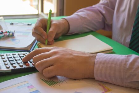 Businessman working on office desk with Calculator,  a pen and document. Businesses conceptの写真素材