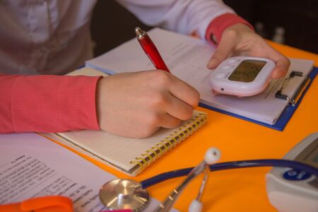 Medicine doctor's working table. Healthcare and medical concept. Female medical doctor writing...