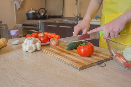 woman hands cutting vegetables on kitchen blackboard. Healthy food. Woman preparing vegetables. Healthy Foodの写真素材