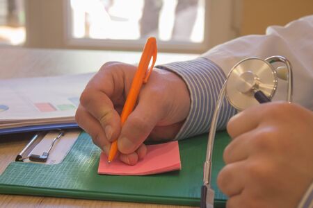 Men medicine doctor hands filling patient medical form. doctor concept