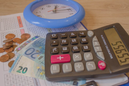 Business, finance, saving money or investment concept: Coin stacks, pen, clock and savings account passbook or financial statementの写真素材