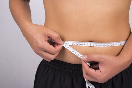 man on isolated background with a tape measureの写真素材