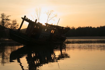 Wreck of fishing boat at dawnの写真素材