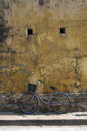 Bicycle leaning against a wall, Hoi An, Vietnamの写真素材