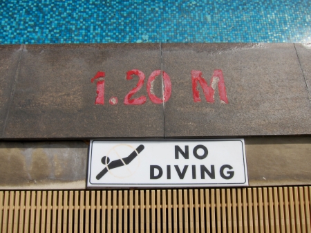 No diving sign and pool depth markings on swimming pool edgeの写真素材
